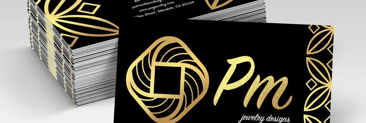 A stack of gold-foil business cards