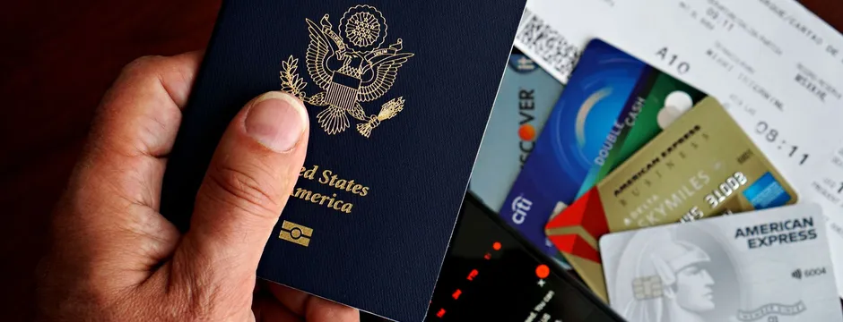 A U.S. passport with a boarding pass and travel cards