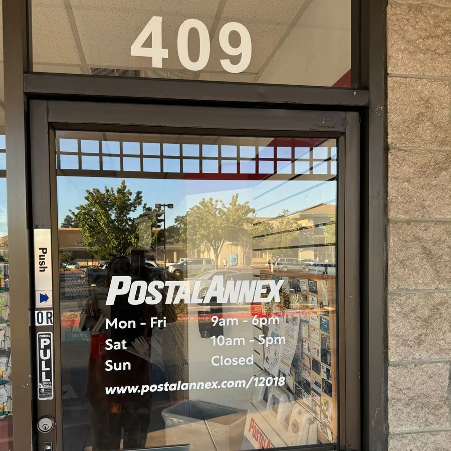 The 409 Tennant Station entrance with hours at PostalAnnex